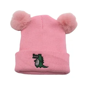 Pink kids knit beanie with double pom-poms and cute green crocodile embroidery patch