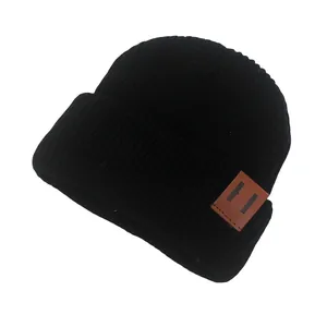 Black ribbed knit baby beanie with a brown leather patch for autumn and winter warmth