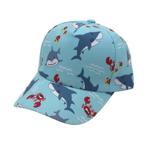 Detailed view of kids cartoon baseball cap featuring shark and crab prints on blue fabric