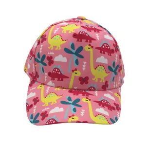 Detail of pink kids baseball cap showing colorful cartoon dinosaur and plant patterns