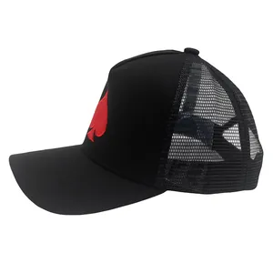 Detailed view of red spade embroidery on breathable black mesh trucker cap