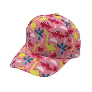 Detailed close-up of pink kids baseball cap featuring colorful cartoon dinosaur prints