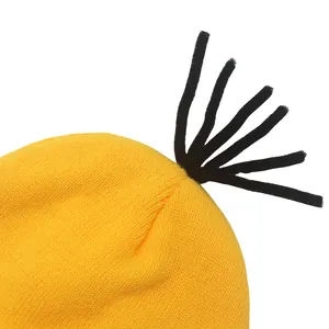 Yellow Minion-inspired knit hat with black fiber hair detail and warm ribbed texture