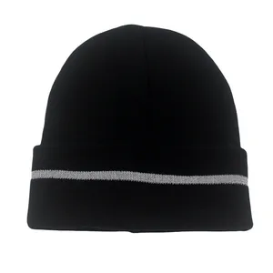 Close-up of black knitted beanie featuring a reflective silver horizontal stripe on the cuff