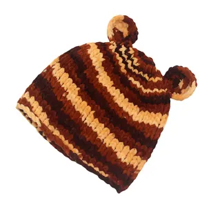 Detailed close-up of handmade chunky knit beanie with striped pattern and bear ears
