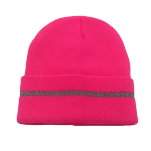 Close-up of bright pink ribbed knit beanie featuring a grey reflective safety stripe detail
