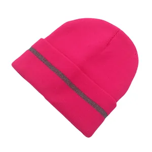 Detail of bright pink knitted beanie featuring a grey reflective safety strip on the cuff
