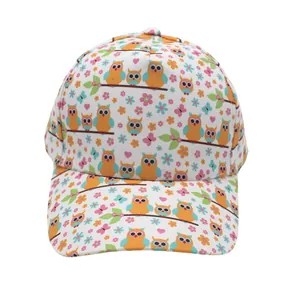 Close-up of six-panel kids baseball cap with cartoon owl and floral print patterns