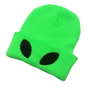 Neon green knitted beanie featuring black alien eye embroidery in a minimalist style