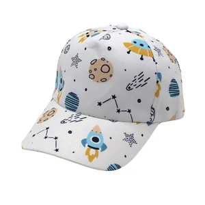 Detail showing space-themed cartoon prints on a white cotton kids baseball cap