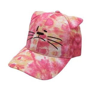 Detailed close-up of pink and yellow tie-dye kids baseball cap with cute cat ear decorations