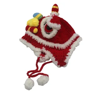 Close-up of traditional lion dance style baby knitted hat with red wool and white pom-poms