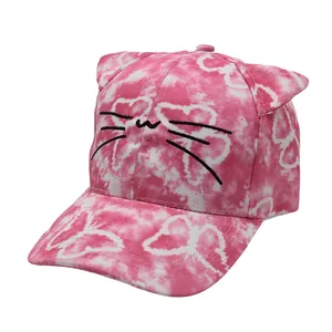 Close-up of pink and white tie-dye kids baseball cap with cat ear design and embroidery