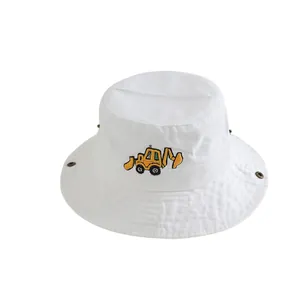 Gros plan d'un chapeau bob en coton blanc avec broderie de pelle jaune et œillets en métal