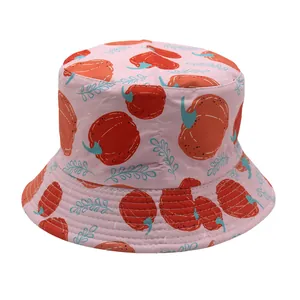 Detailed view of pink kids bucket hat featuring cartoon pumpkin and leaf patterns