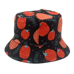Detail of kid's black bucket hat featuring festive orange pumpkin and vine leaf patterns