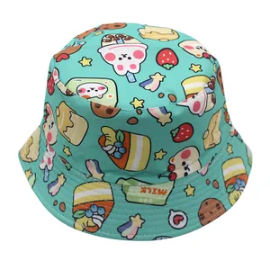 Close-up of kids bucket hat with colorful cartoon bears and dessert prints on blue fabric