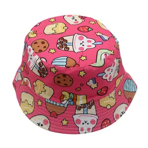 Detail of pink kids bucket hat featuring cute cartoon bear and cupcake pattern prints