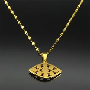 Detail view of gold evil eye pendant on twisted rope chain with mirror reflection