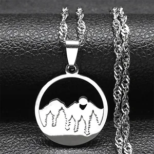 Macro shot of stainless steel layered necklace featuring moon and forest pendant details