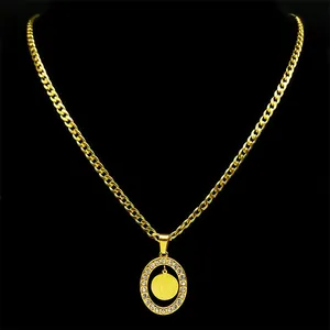 Gold Saint Benedict pendant necklace with crystal border on a thick curb chain