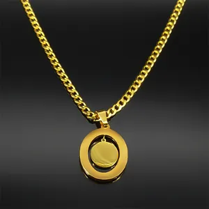 Detailed close-up of a gold Saint Benedict medal pendant with a Cuban chain necklace