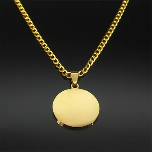 Polished gold round pendant with cuban link chain on black reflective surface