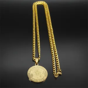 Macro shot of gold Saint Michael pendant with Cuban chain on a reflective black background