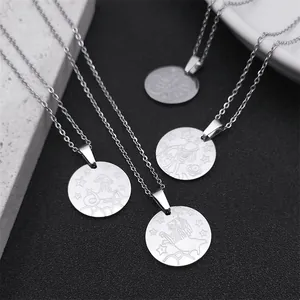Macro view of four silver zodiac coin pendants with laser engraved constellation motifs
