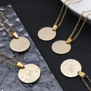 Detailed close-up of gold zodiac constellation pendant necklaces with embossed metal motifs