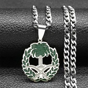 Macro detail of silver stainless steel curb chain with Saudi emblem pendant and green enamel