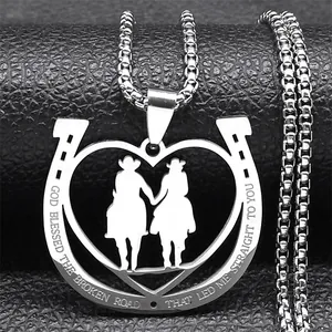 Macro view of horseshoe heart pendant with engraved quote on stainless steel necklace