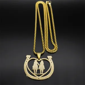 Detail of gold horseshoe pendant with couple silhouette and God Bless engraving