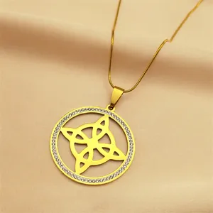 Detail of gold-plated stainless steel necklace with crystal-encrusted witch's knot pendant