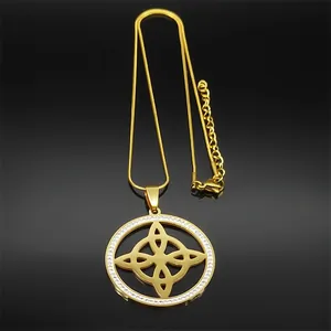 Detail view of gold circular necklace with zircon knot pendant and snake chain