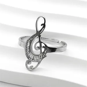 Close-up of polished silver treble clef music note ring with adjustable open band