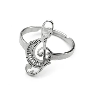 Macro detail of silver musical treble clef ring with adjustable open band design