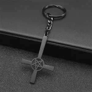 Detail of gothic black metal inverted cross keychain with pentagram and matte finish
