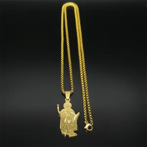 Detailed close-up of golden religious saint pendant with fine bead chain on black background