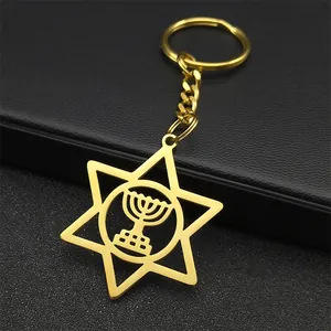 Macro shot of gold stainless steel hexagram keychain with hollow menorah religious design
