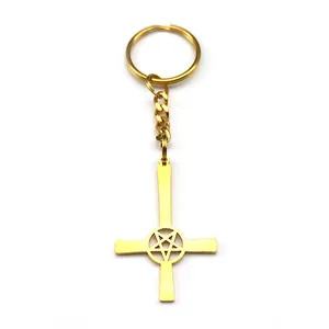 Polished gold metal inverted cross keychain featuring a hollow pentagram pendant design