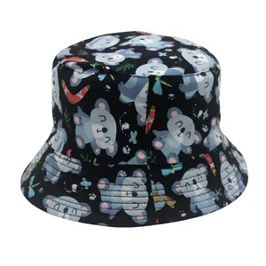 Detail of reversible kids bucket hat with koala print and floral patterns on black fabric