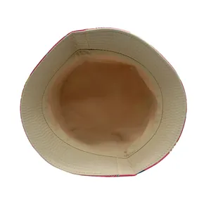 Detail of the inner stitching and beige plain fabric of a double-sided kids bucket hat