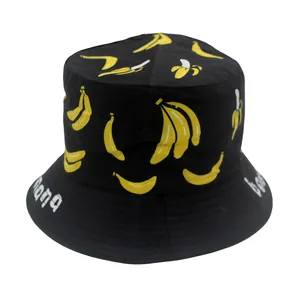 Detail of black kids bucket hat featuring cartoon banana patterns and white text print