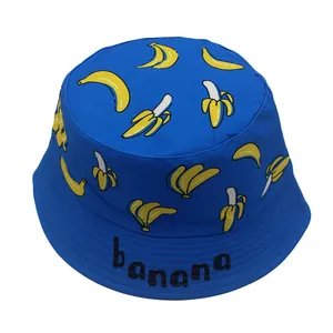 Detail of blue cotton bucket hat for kids with yellow banana prints and banana text