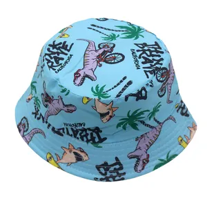 Detail of light blue bucket hat featuring cartoon dinosaurs and palm tree patterns