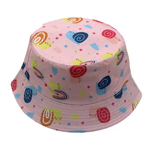 Detail of pink cotton bucket hat featuring colorful cartoon snail prints and reinforced stitching