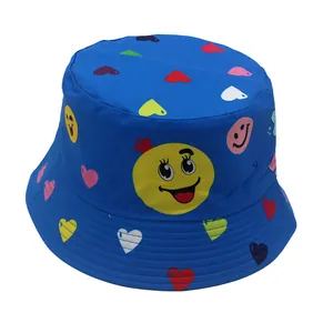 Kids reversible bucket hat with blue base and colorful smiley face heart patterns