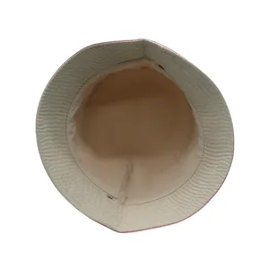 Detail of pink cartoon shark bucket hat showing beige cotton lining and reinforced stitching