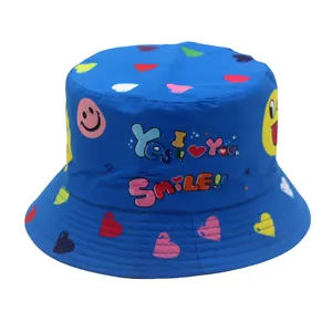 Detail of blue kids bucket hat with graffiti smiley faces and colorful heart prints